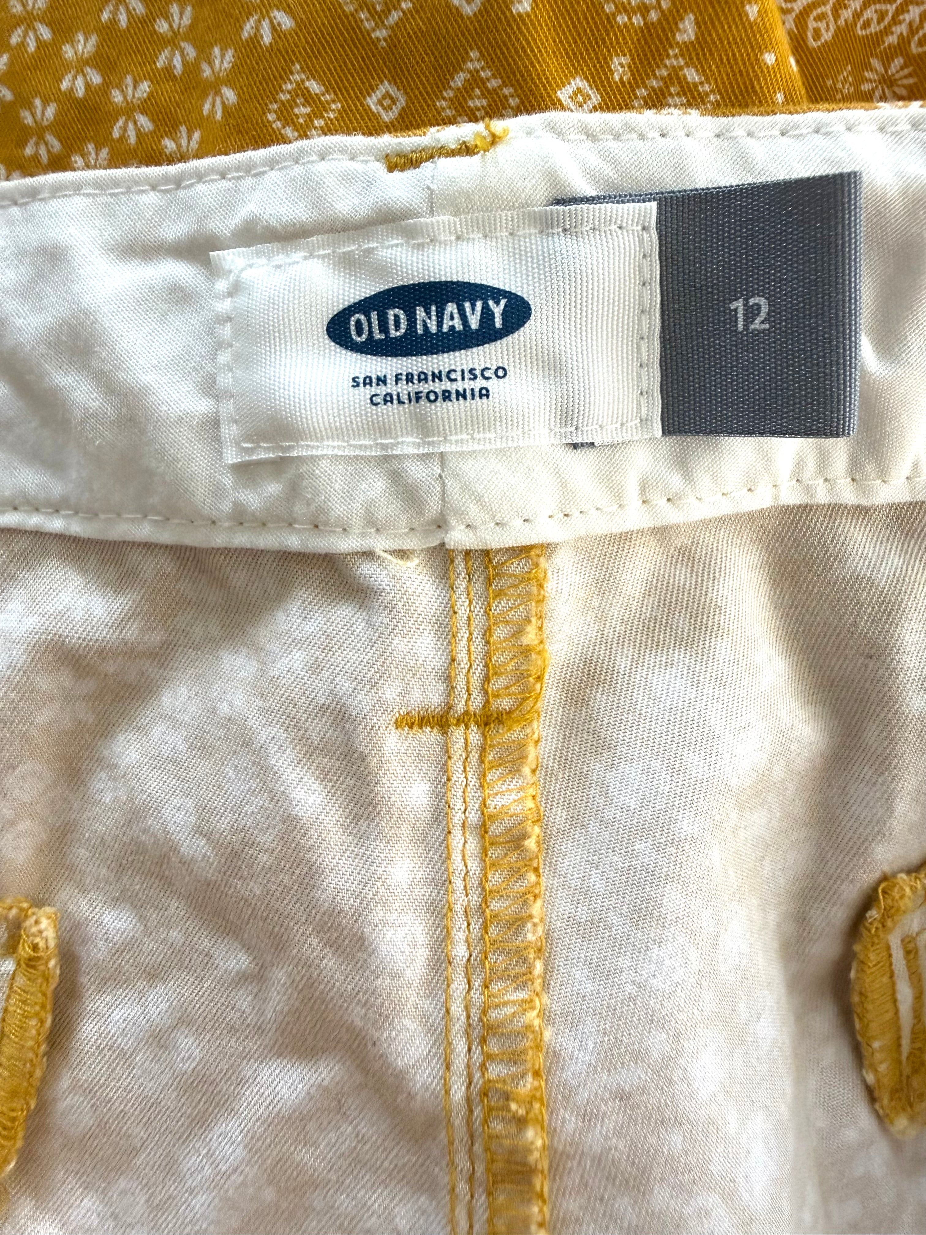 inside tags on NWT Old Navy 100% Cotton Mustard Floral Print Chino Shorts — 5" | Size 12 at Blue Sparrow Shop