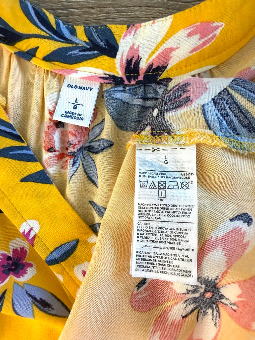 inside tags on Old Navy Floral Sleeveless V-Neck Blouse — Golden Yellow | Coral and Navy Print | Size L at Blue Sparrow Shop
