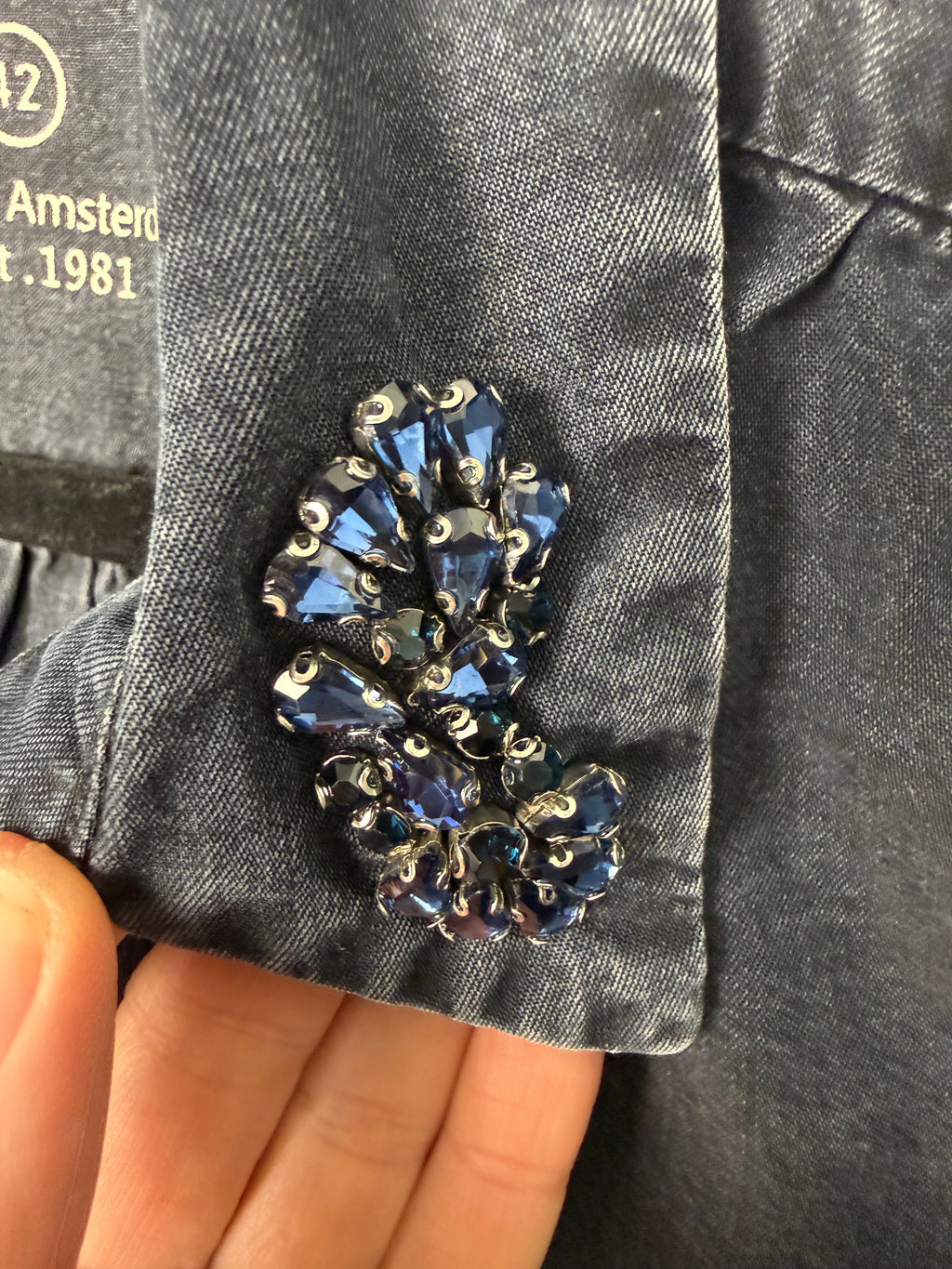 jewel detail on Sandwich Denim Studio Amsterdam charcoal 100% Tencel shirt with stunning hand-applied blue crystal collar embellishment and ruffle cuff detail at Blue Sparrow Shop