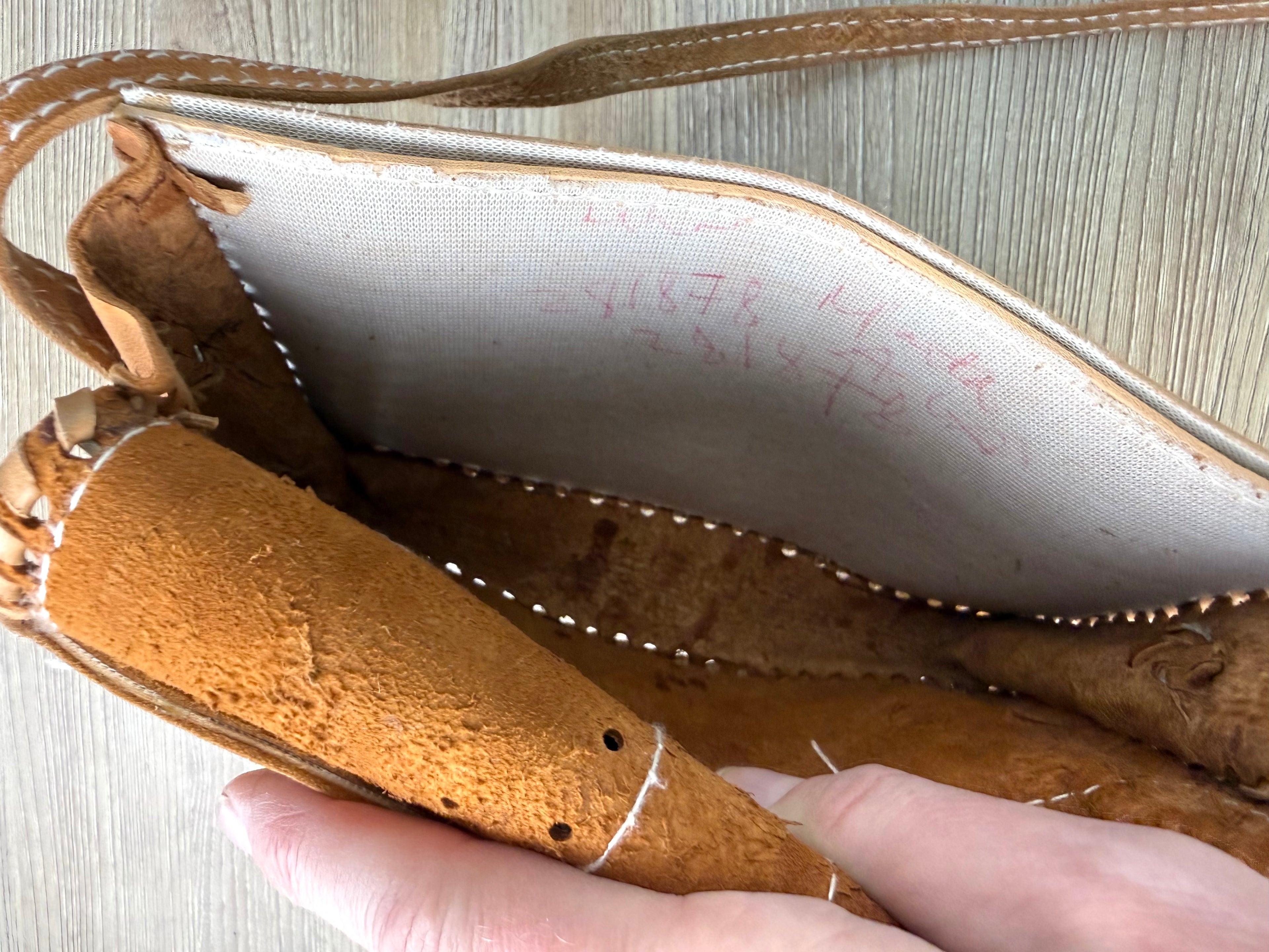 lettering on back of inside flap on front of intage Hand-Tooled Leather Crossbody Bag at Blue Sparrow Shop