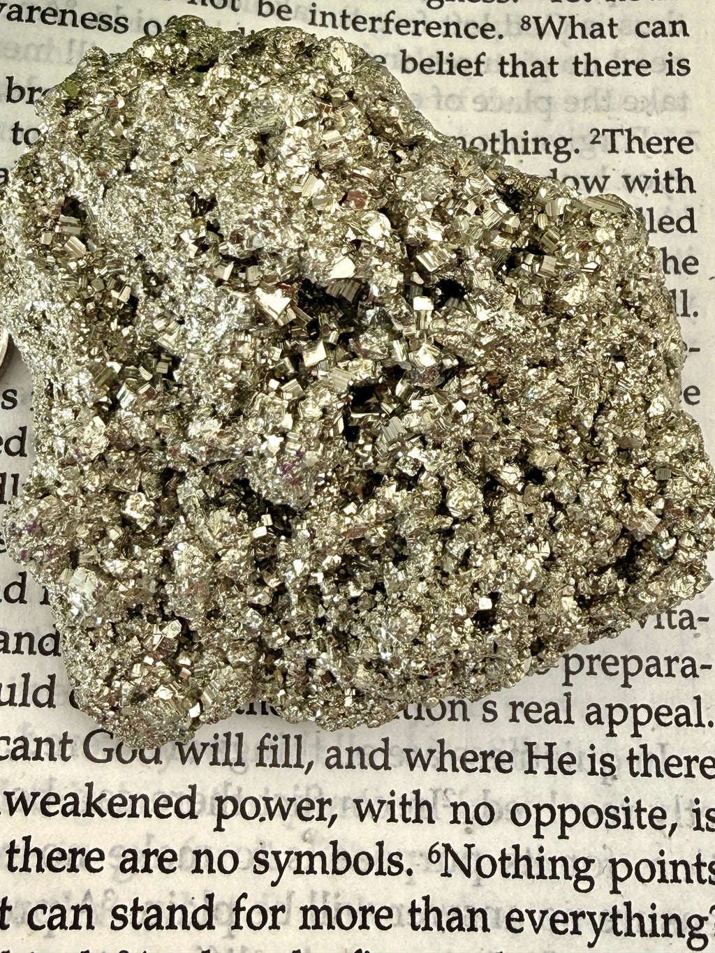close up of pyrite chunk on book
