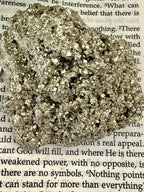 close up of pyrite chunk on book