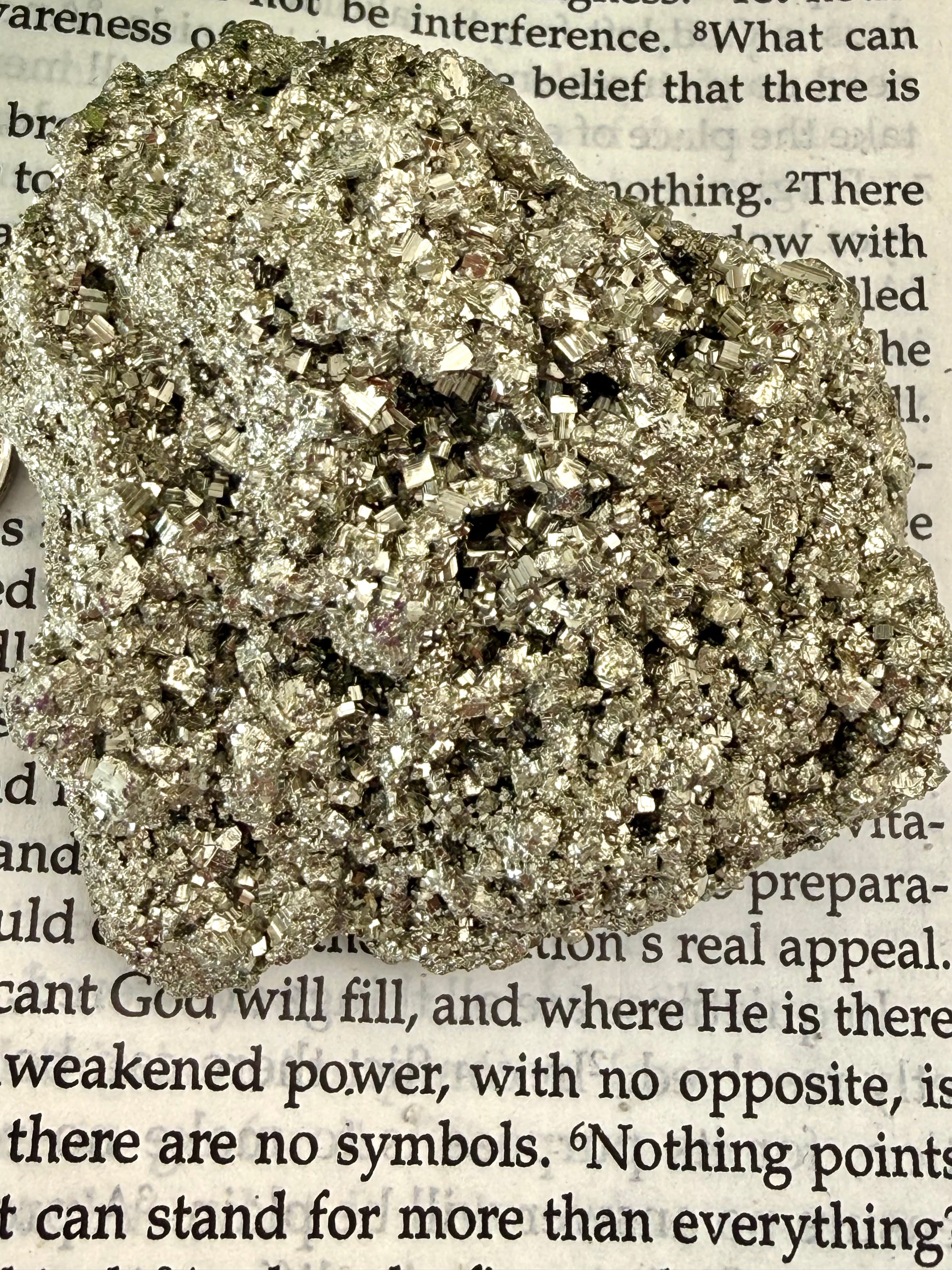 close up of pyrite chunk on book