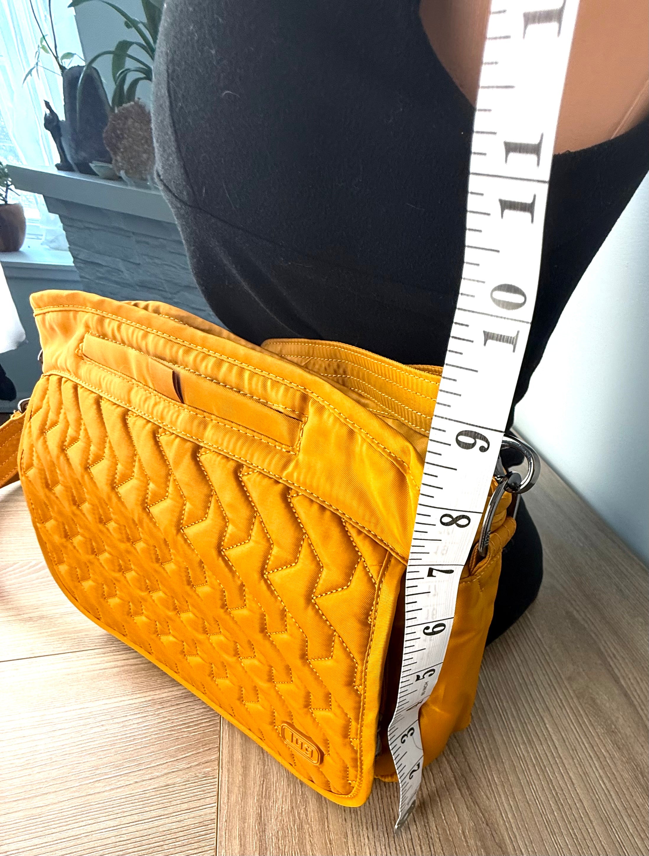 lug travel cross body bag measuring approx 9" deep 