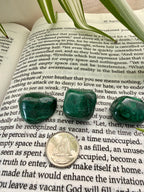 3 malachite stones on the course in miracles book with a dime to show scale 
