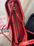 Gold zipper detail on red leather Laurentian Chief crossbody bag