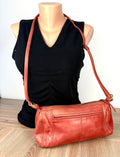 other side of Derek Alexander Leather Crossbody Bag on mannequin 