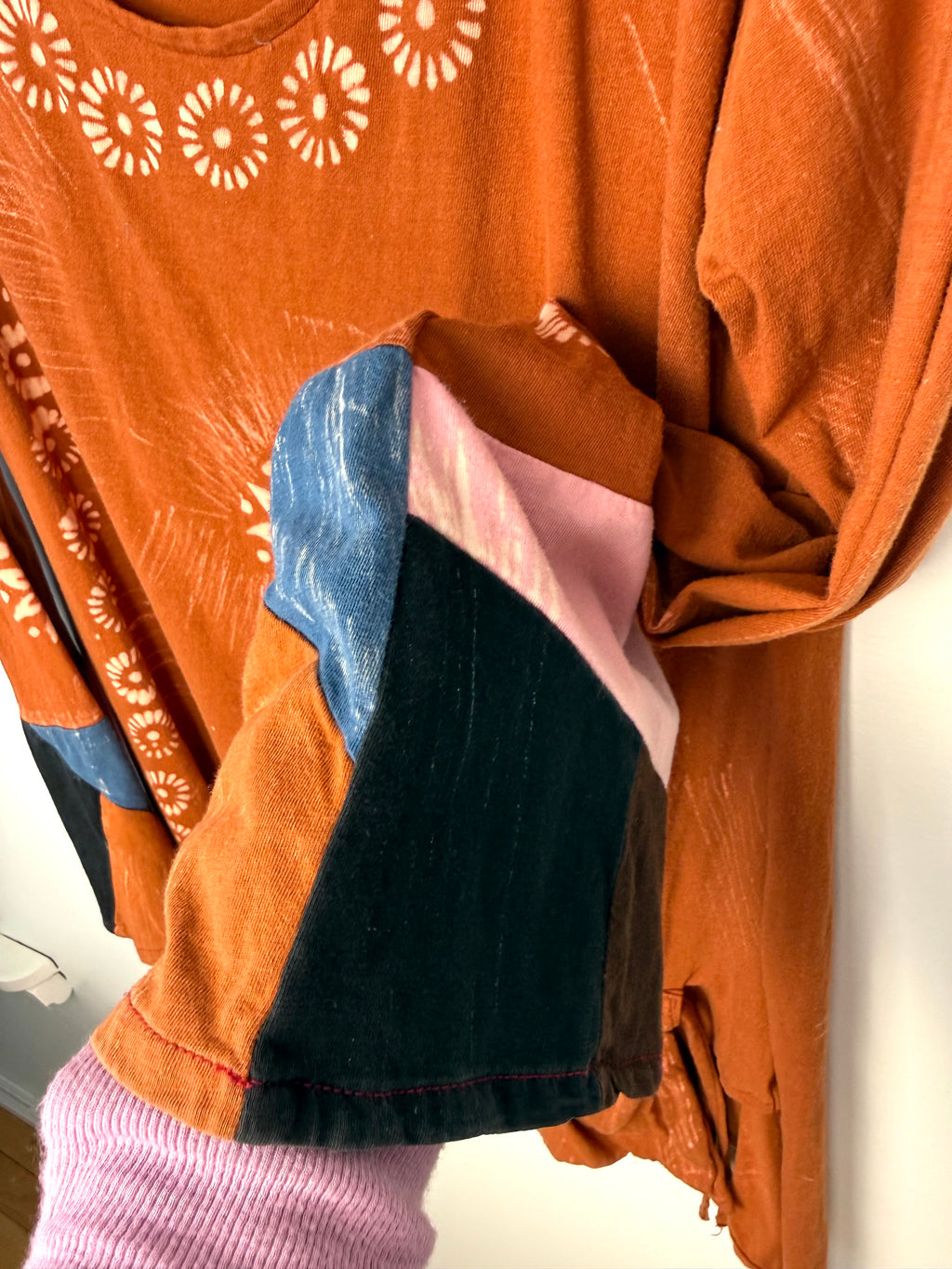 patchwork sleeve detail on Tye dye boho artsy unique asymmetrical top in burnt orange  