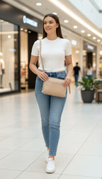 pelle-rfid-leather-crossbody-bag_at Blue Sparrow Shop woman walking in mall 