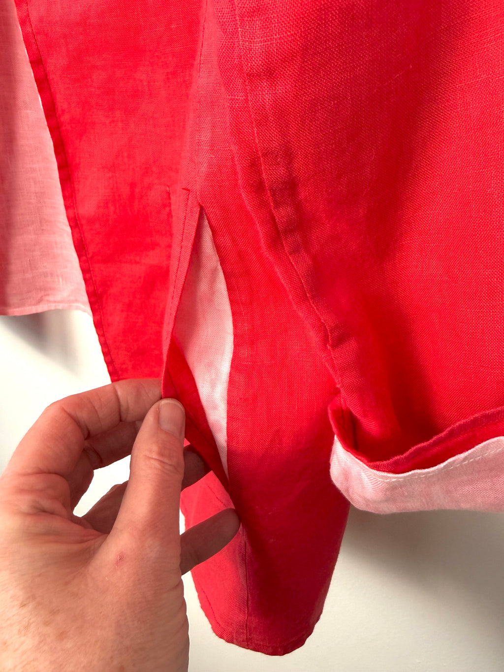 pocket detail on Lightweight linen jacket resort wear capsule wardrobe essential with someone holding it open