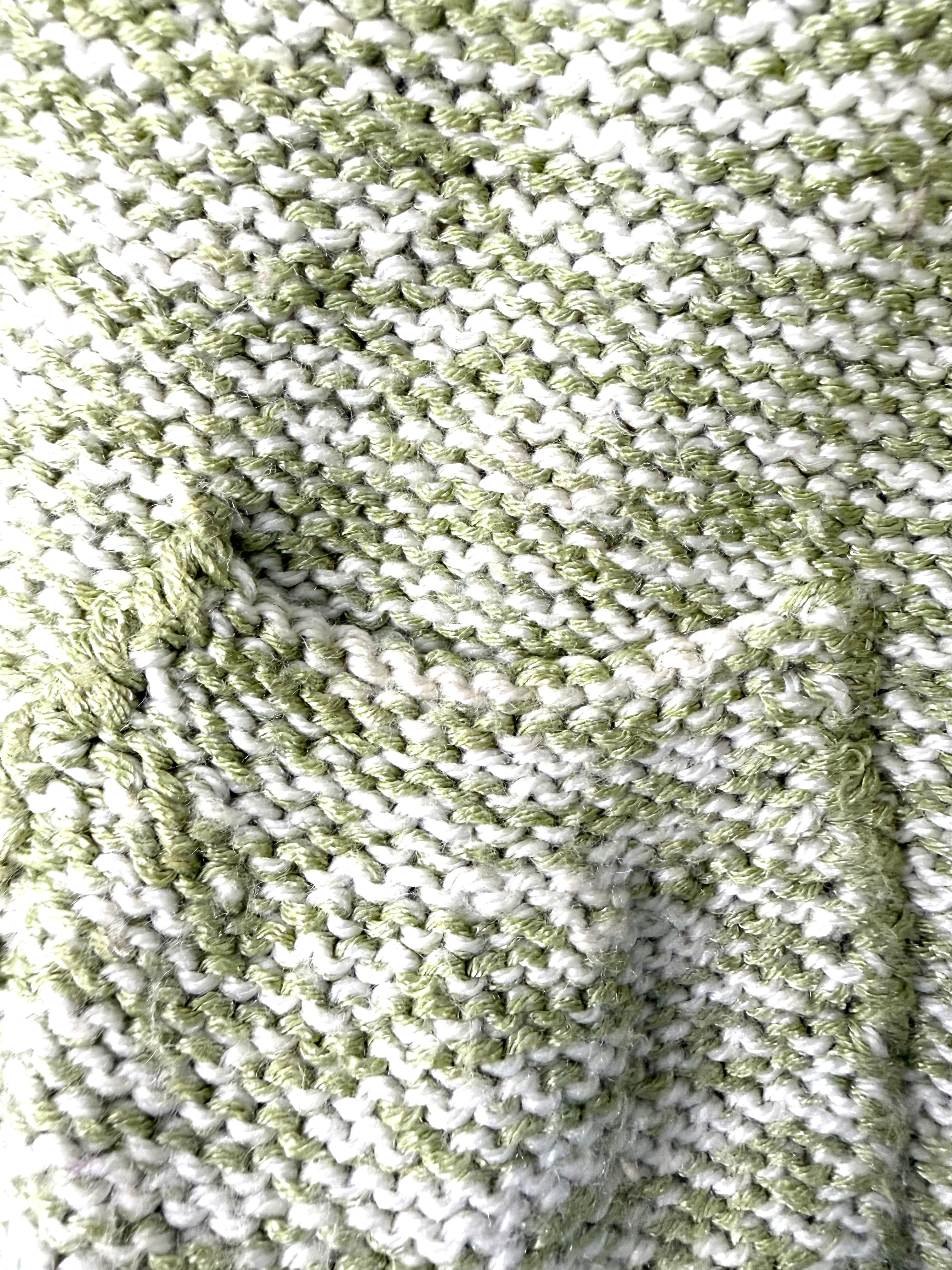pocket detail on hand knit marled yarn green and white artisan sweater detail
