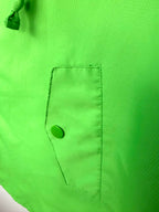 pocket detail on lime green spring poncho for women 