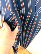 pocket detail on navy, orange and white vertical stripe jumpsuit.