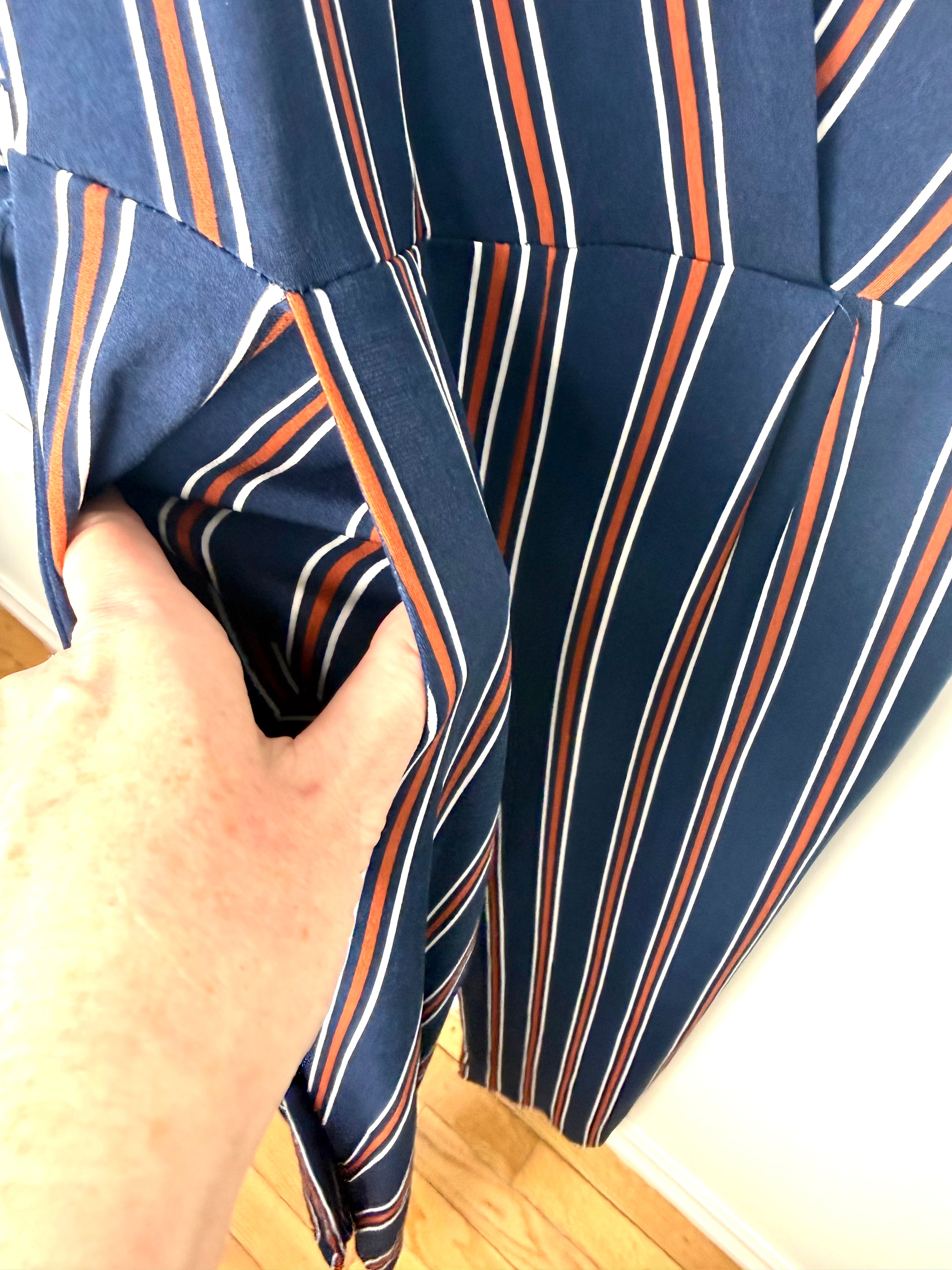 pocket detail on navy, orange and white vertical stripe jumpsuit.
