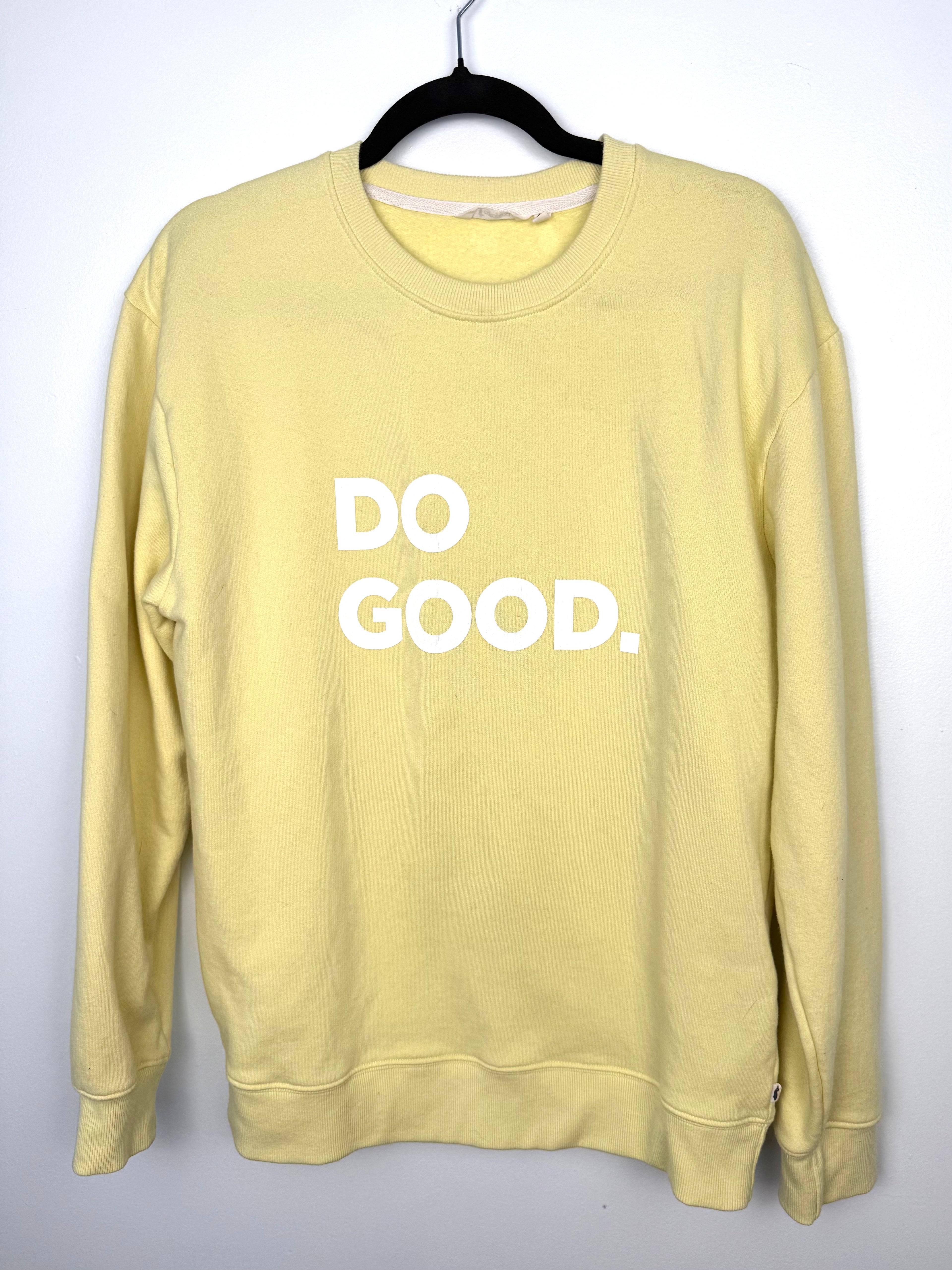 front view Cotopaxi pastel yellow crewneck sweatshirt with white “DO GOOD.” graphic.