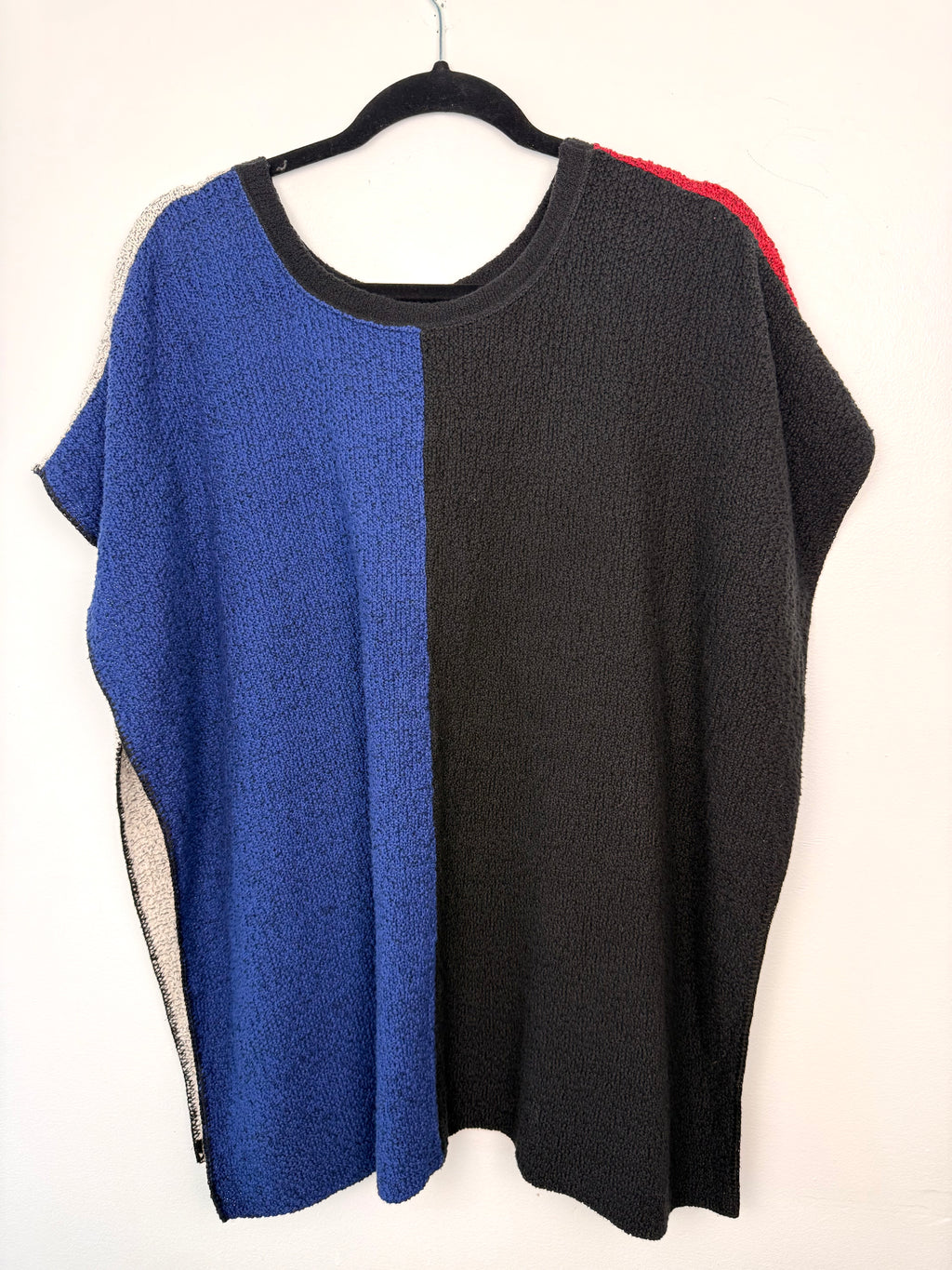 reverse side of Margaret Winters Reversible Cotton Colour Block Poncho Top | One Size on hanger