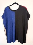 reverse side of Margaret Winters Reversible Cotton Colour Block Poncho Top | One Size on hanger