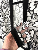 sleeve detail on Black and white floral lace open front cardigan, lightweight sheer lace jacket with cropped silhouette and 3/4 sleeves