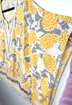sleeve on Made in Italy Boho floral kaftan top with yellow and cream print, crochet V neckline, and tassel hem, lightweight Italian viscose blouse
