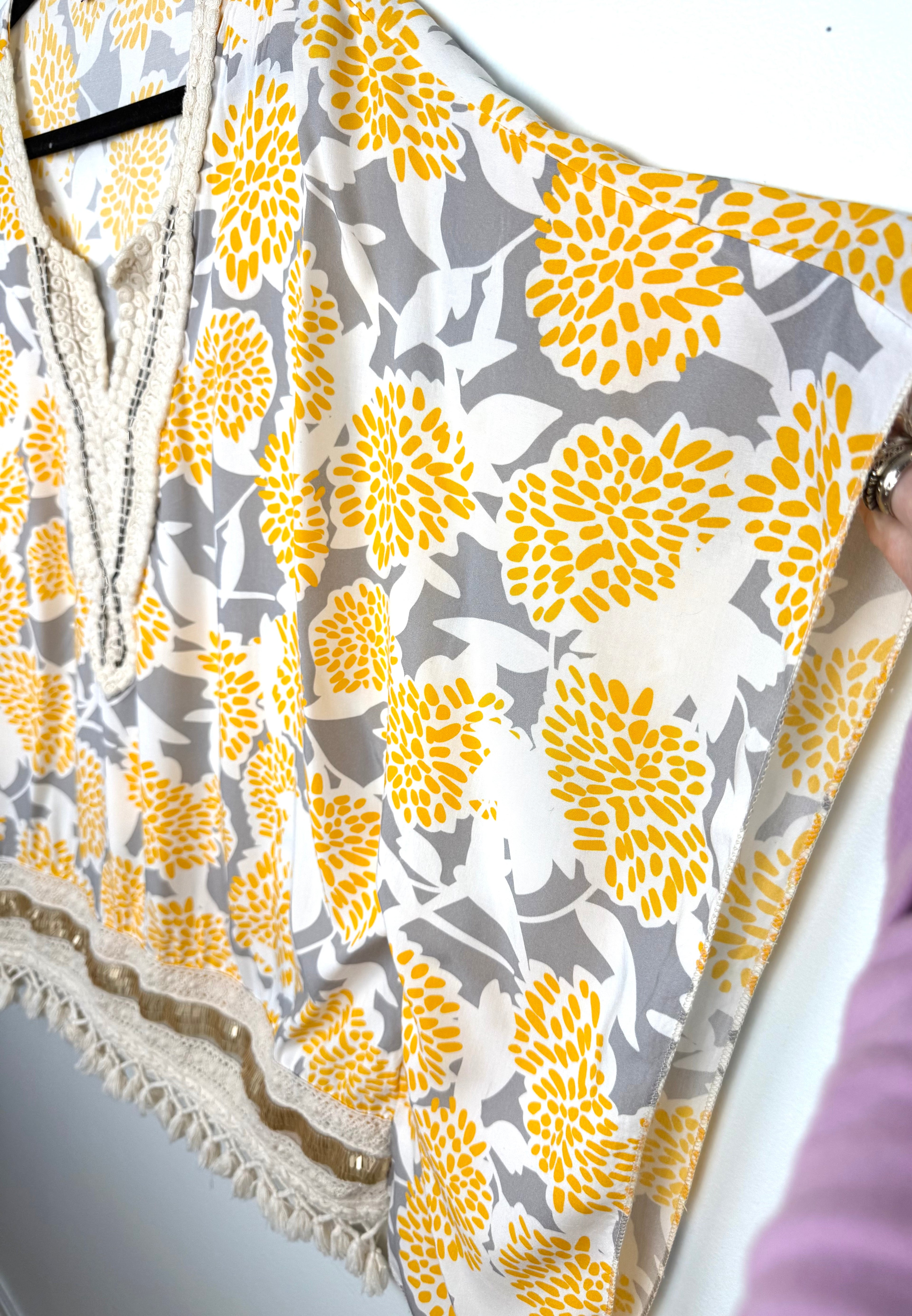 sleeve on Made in Italy Boho floral kaftan top with yellow and cream print, crochet V neckline, and tassel hem, lightweight Italian viscose blouse