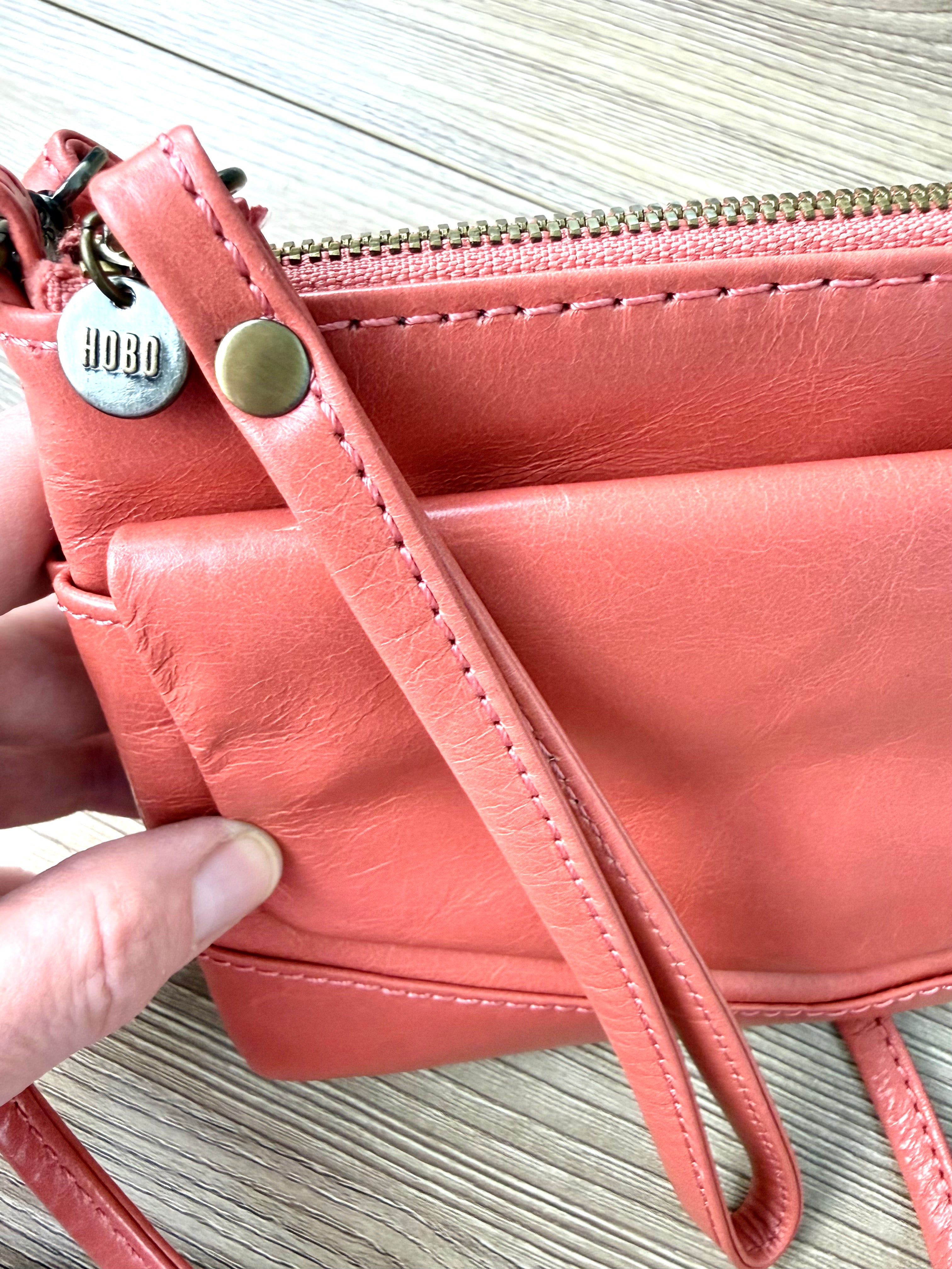 top of Coral Coloured HOBO International Leather Crossbody Wristlet Bag 