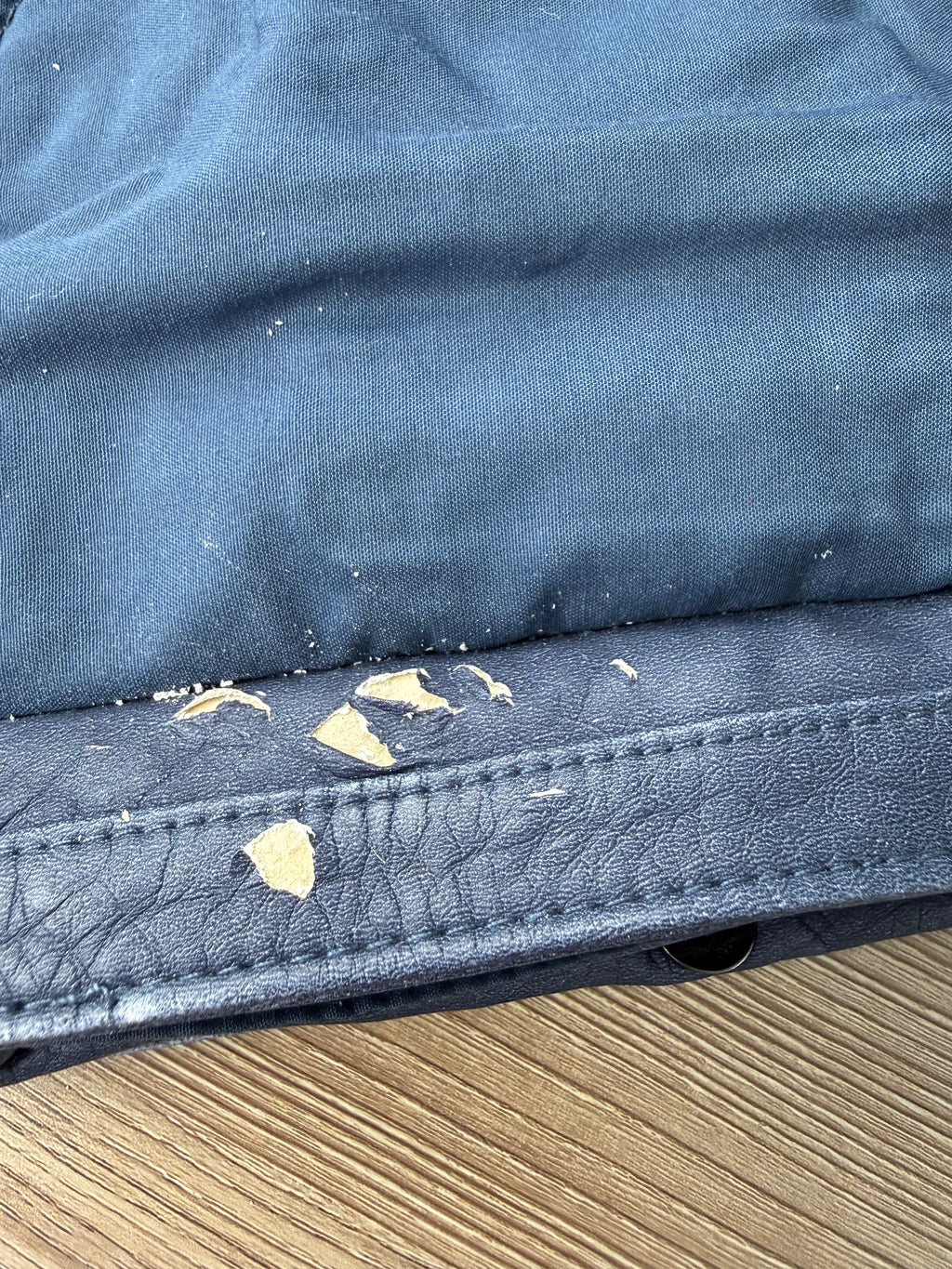 vegan leather peeling up close pic under front flap on Blue Vegan Leather Mini Chain Crossbody Bag 