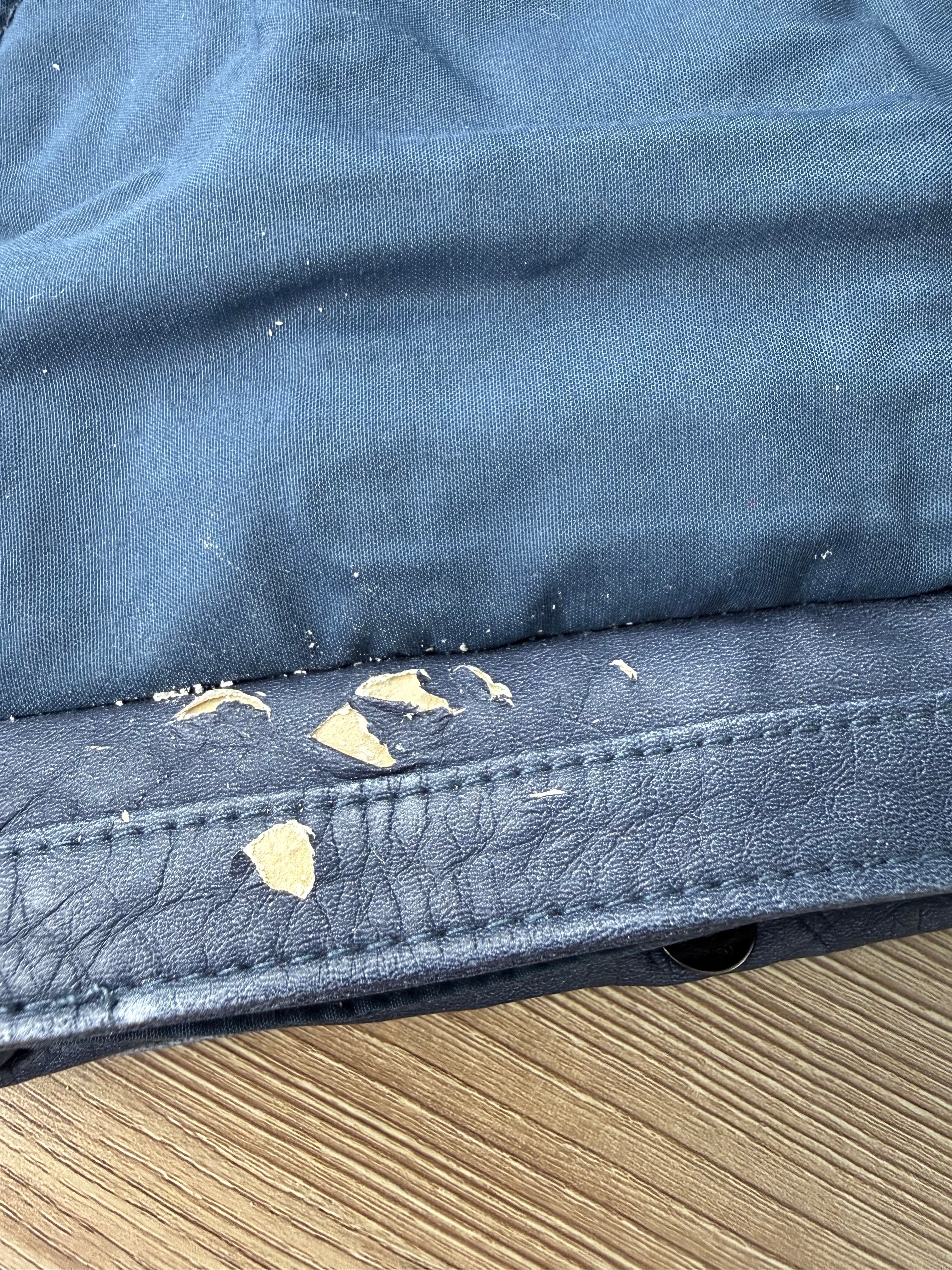 vegan leather peeling up close pic under front flap on Blue Vegan Leather Mini Chain Crossbody Bag 