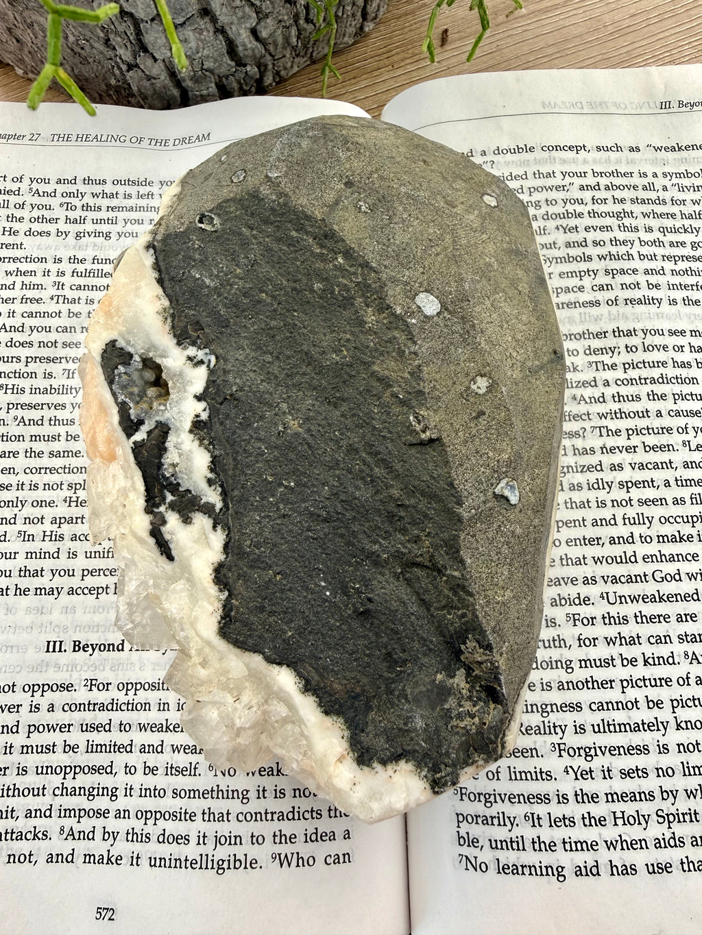 back of apophyllite crystal on a book 