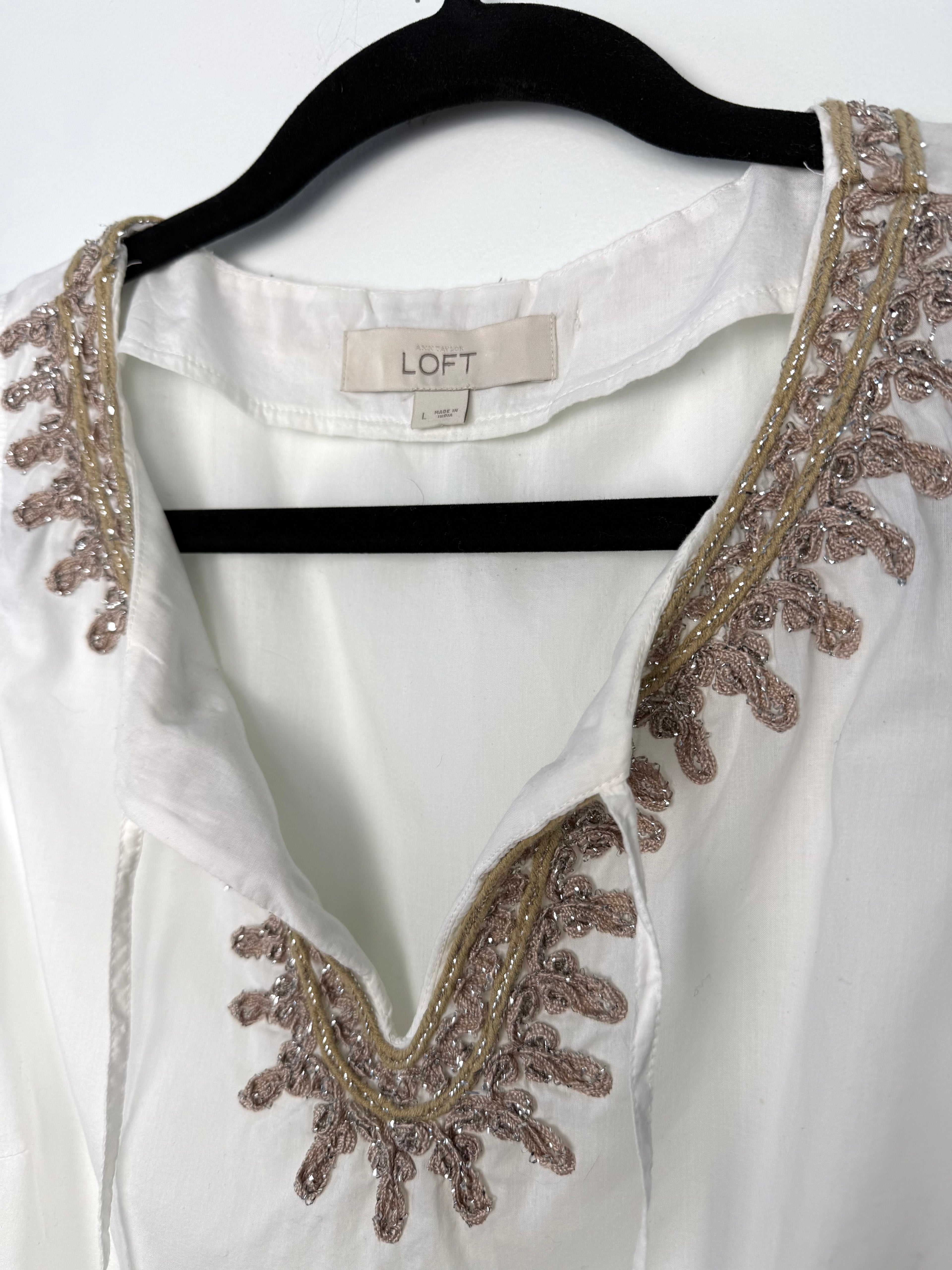 white v neck blouse with gold and blush embroidery detail close up
