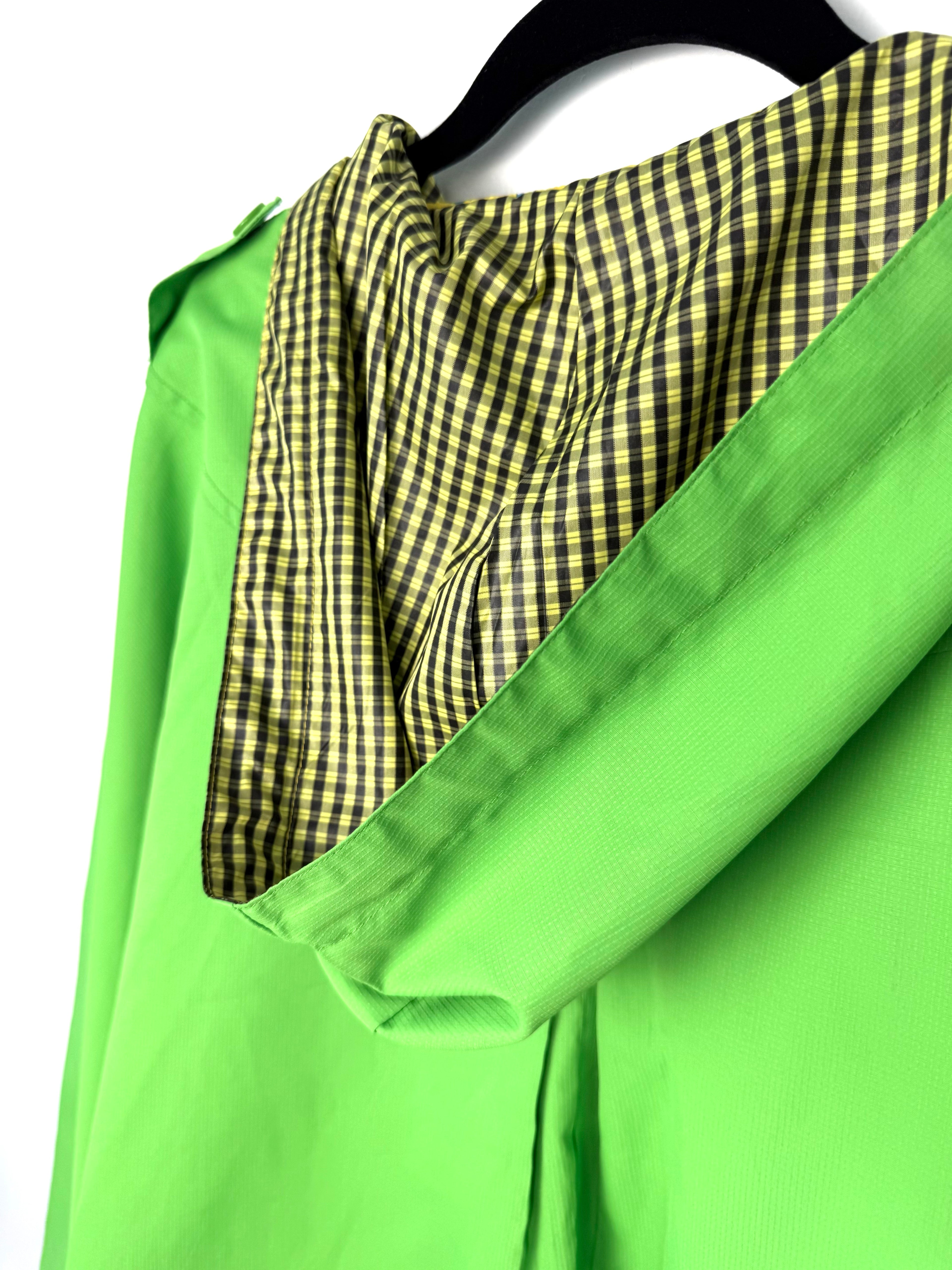 women’s statement raincoat bold neon green outerwear showing checkered hood