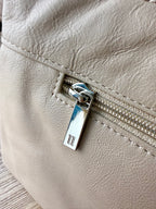 zipper pull with logo on pelle-rfid-leather-crossbody-bag 